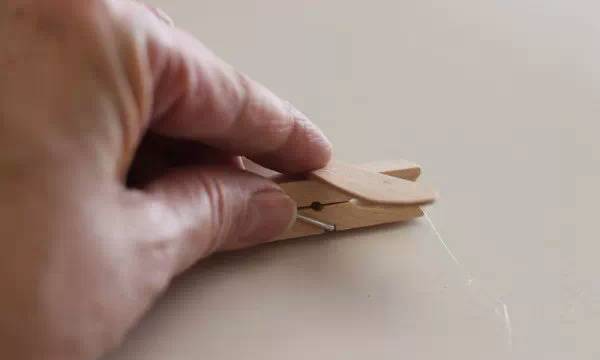 Press the popsicle stick onto the hot glue
