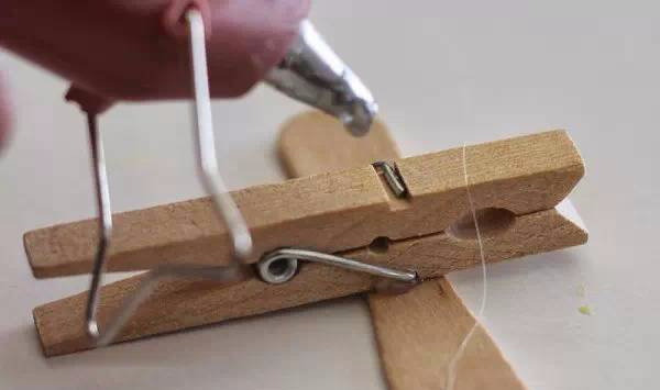 Put hot glue on the reverse side of the clothespin as well.