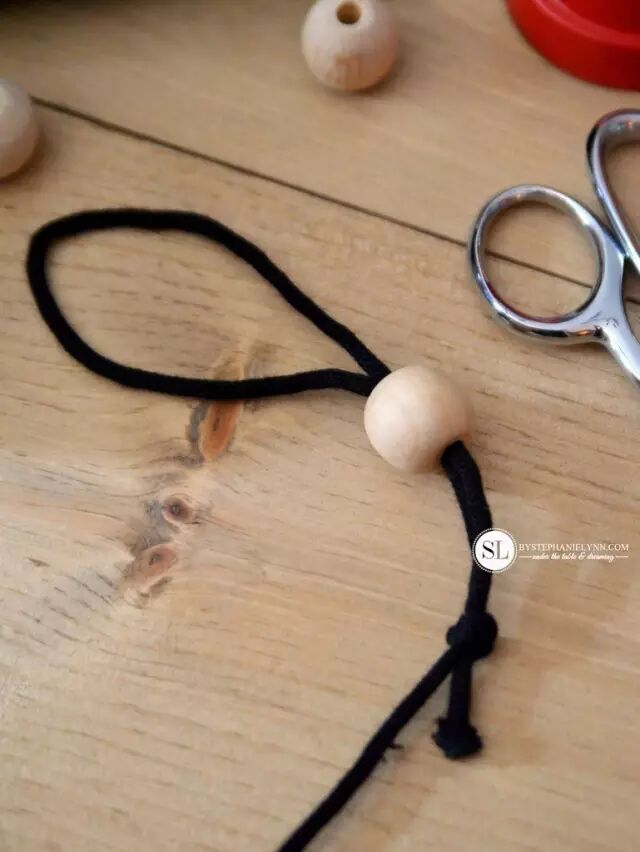Prepare slightly thick and strong string, tie a knot and thread on small wooden beads as a handle