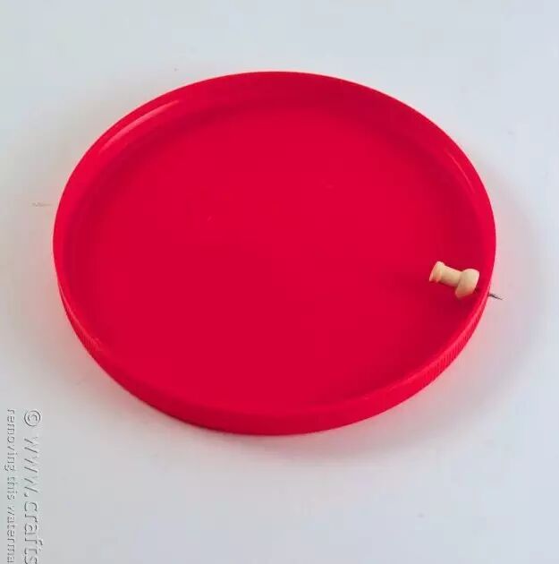 Use a hole punch or pin to make small holes in the plastic plate
