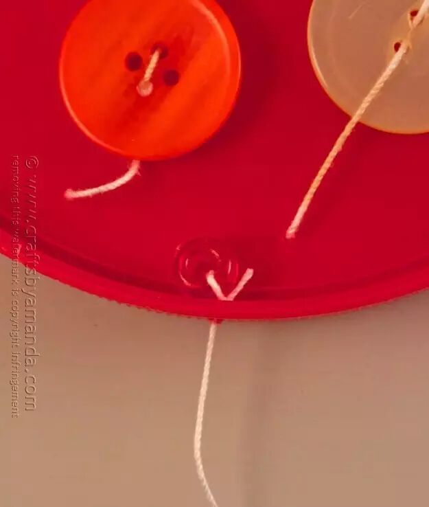 Thread the buttons through the small holes with thin string