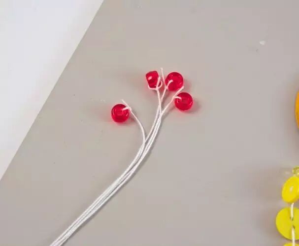 Thread small beads or plastic plates at the end of the string as decoration