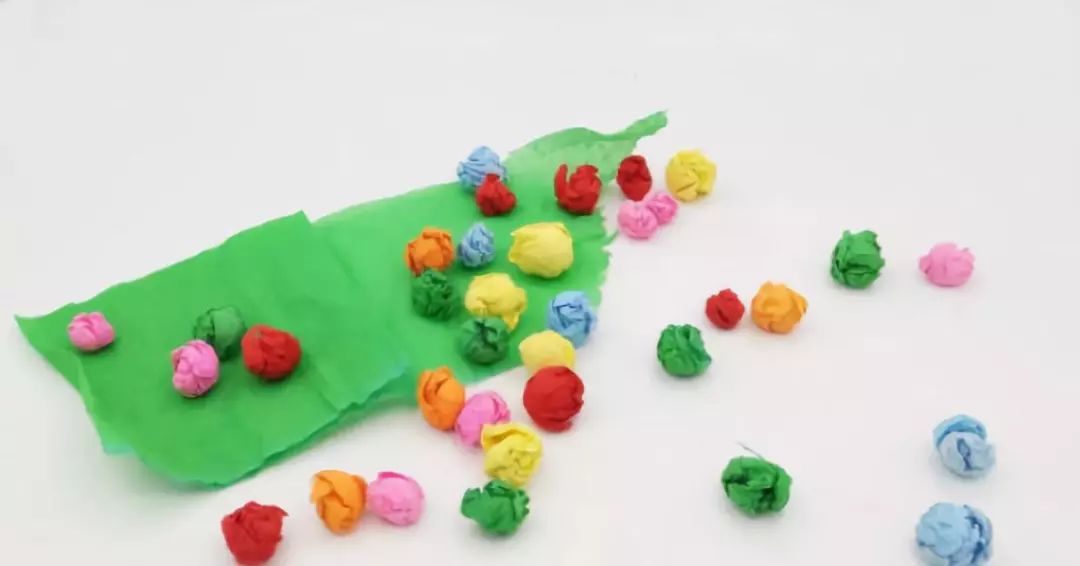 Crumple colorful crepe paper into small balls as eggs