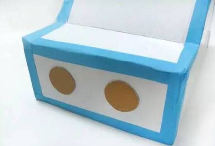 Cut two circles and paste them on the front as lights